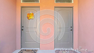 Panorama frame Front doors and porch of pink townhouse duplex Stock Photo