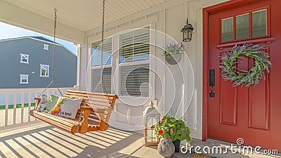 Panorama frame Front porch of alternative home and swinging chair Stock Photo