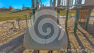 Panorama frame Slide on a playground with the sun shining brightly in the background Stock Photo
