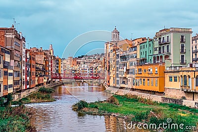 Panorama of Girona with red metal lattice Eiffel Bridge over the river Onyar Stock Photo