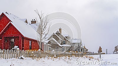 Panorama Gorgeous houses with picket fences on a wintry landscape in Daybreak Utah Stock Photo