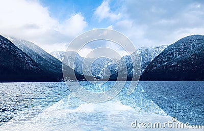 Panorama of Hallstatt lake outdoor with snow mountains with reflection in the water in Austria in Austrian alps Stock Photo