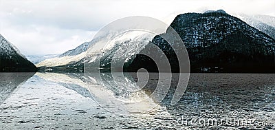 Panorama of Hallstatt lake outdoor snow mountains with reflection in the water in Austria in Austrian alps Stock Photo