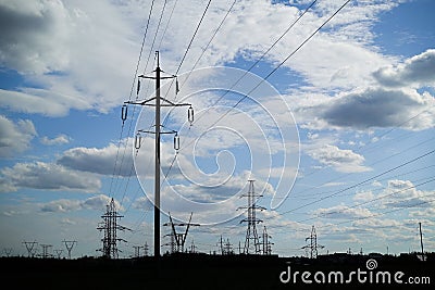 Panorama of high voltage substation. Distribution electrical power. Silhouettes of pylons and towers Stock Photo