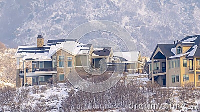 Panorama Hilly residential terrain with charming homes and snowy natural beauty Stock Photo