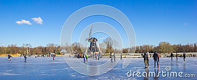 Panorama of the historic windmill at the frozen lake in Groningen Editorial Stock Photo