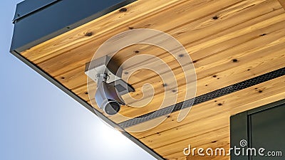 Panorama Home with security camera installed on the wooden underside of its roof Stock Photo