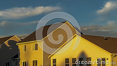 Panorama Houses with horizontal wall siding and outdoor stairs leading to the balconies Stock Photo