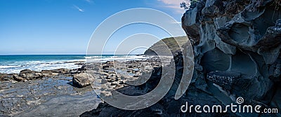 Panorama of intricate rock formations on ocean coastline. Stock Photo