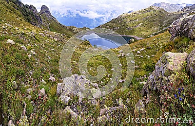 Panorama landscape with a lake in the mountains, huge rocks and Stock Photo