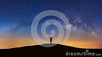 Panorama landscape with milky way, Night sky with stars and silhouette of a standing sporty man with raised up arms on high mount Stock Photo