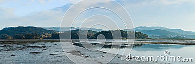 panorama of marshes with forests and mountains in the background at sunset Stock Photo