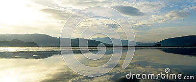 panorama of marshes with forests and mountains in the background at sunset Stock Photo
