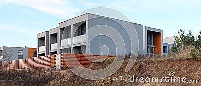 Panorama of a modern standard no name unfinished houses on wet Stock Photo