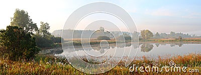 Panorama of morning lake in fog Stock Photo