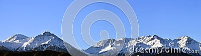 Panorama of mountain peaks with freshly fallen white snow. Stock Photo