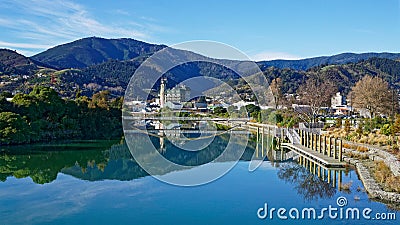 Panorama of Nelson City, reflected in the Maitai River, New Zealand Stock Photo