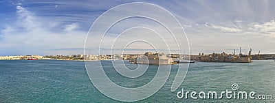 Panorama photo of the Valletta city Grand harbor area at Malta, with many historic buildings along the coastline Stock Photo