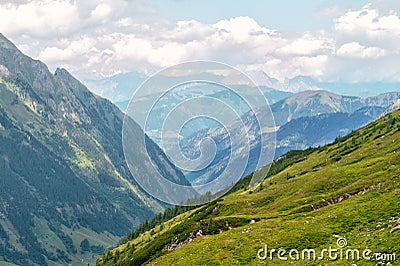 Panorama of picturesque blue mountainsides and green alpine meadows, Austria Stock Photo