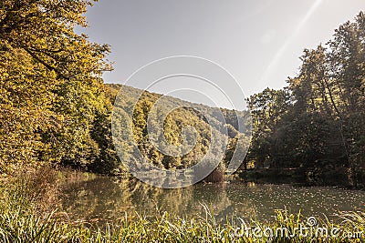 Panorama of the pond Jankovac, a small water lake surrounded by trees and forest in the Papuk mountain, a major national park of Stock Photo