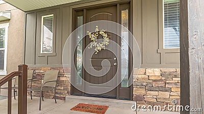 Panorama Porch and front door of a home with wood and stone brick wall sections Stock Photo