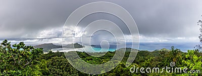 Panorama of Praslin Island with La Digue Island on the horizon, with tropical rainforest around, azure ocean, Seychelles. Stock Photo