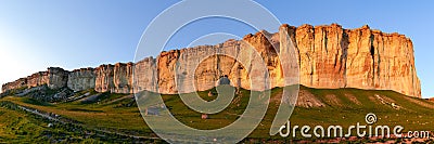 Panorama of precipitous limestone rock against clear sky at sunset Stock Photo