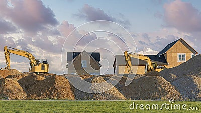 Panorama Puffy clouds at sunset Construction sand piles with two excavators at Utah Stock Photo