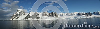 Panorama - Reflections of glacial icefalls and mountains, with cloudy blue sky Stock Photo