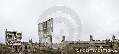 Panorama. The remains of a large destroyed building with piles of construction debris Stock Photo