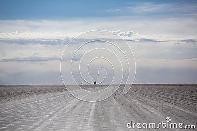 Panorama of the Salar of Uyuni with silhouette of 4x4 cars, Boli Stock Photo