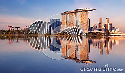 Panorama of Singapore city skyline at business modern downtown building area in sunrise with cloud and sun light and reflection Editorial Stock Photo