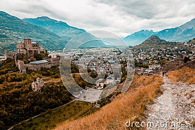 Panorama of Sion city, Rhone Valley and medieval Valere Basilica seen from Tourbillon Castle hill, canton Valais Stock Photo