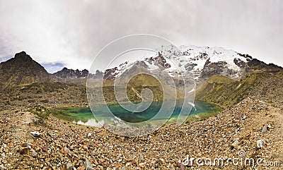 Panorama of snow-covered Andes mountains and blue lake Stock Photo