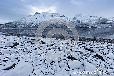 Panorama of snowy fjords and mountain range, Senja, Norway Amazing Norway nature seascape popular tourist attraction. Stock Photo