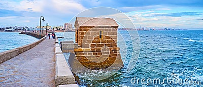 Panorama of the stone levee, watchhouse and waters of Bay of Cadiz, Spain Stock Photo