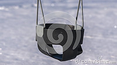 Panorama Swing seat in a kids playground in winter Stock Photo