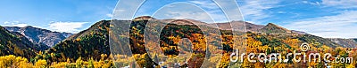 Panorama view of Arrowtown, New Zealand. Beautiful green yellow orange and red autumn trees with the town. I Stock Photo