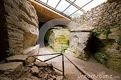 Panorama view of central room in ancient pagan cave temple with figures of tree, woman and deer carved in stone, symbols of life Editorial Stock Photo