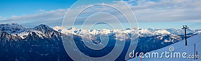 Panorama view of chairlift and ski slope with mountain landscape Stock Photo