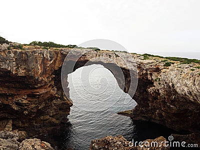 Panorama view of natural arch rock bridge at Cala Varques Calo Blanc Mallorca Majorca Balearic Mediterranean Spain Stock Photo