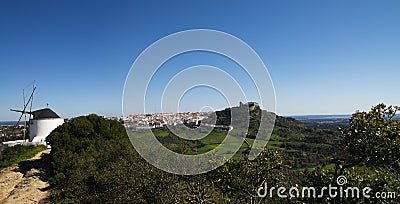 Panorama of wind mill and Palmela under blue sky. Portugal Stock Photo