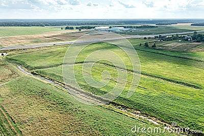 Panoramic aerial view of agricultural fields with irrigational channels and farm Stock Photo
