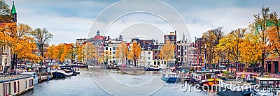 Panoramic autumn view of Amsterdam city. Famous Dutch channels and great cityscape. Gloomy morning scene of Netherlands, Europe. T Stock Photo