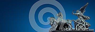 Panoramic banner of ancient bronze quadriga statue of goddess of Victory at Austrian Parliament roof in Vienna with gradient blue Stock Photo