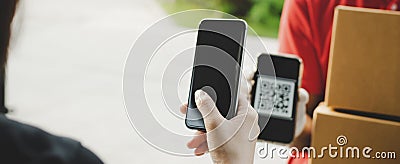 Panoramic banner. hand using digital mobile phone scan QR code paying for receive parcel post box from delivery service man at doo Stock Photo