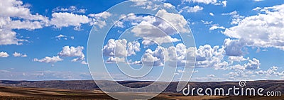 Panoramic clouds over hills Stock Photo