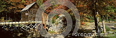 Panoramic of Glade Creek Grist Mil and autumn reflections and waterfall in Babcock State Park, WV Stock Photo