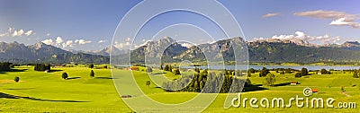 Panoramic landscape in region Allgaeu with lake and alps mountains Stock Photo