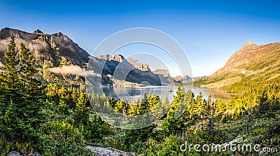 Panoramic landscape view of Glacier NP mountain range and lake Stock Photo